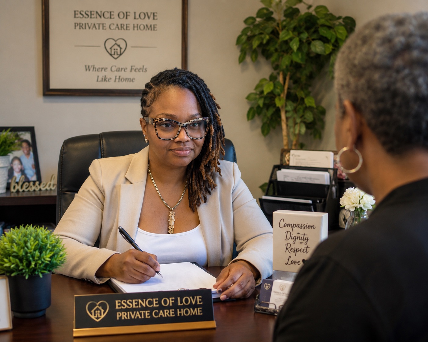 The founder of Essence of Love meeting warmly with a family member at her desk
